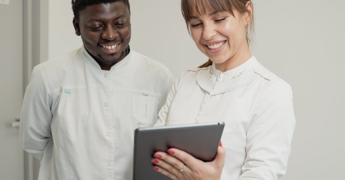 Medical professionals in a hospital setting collaborating with a digital tablet.